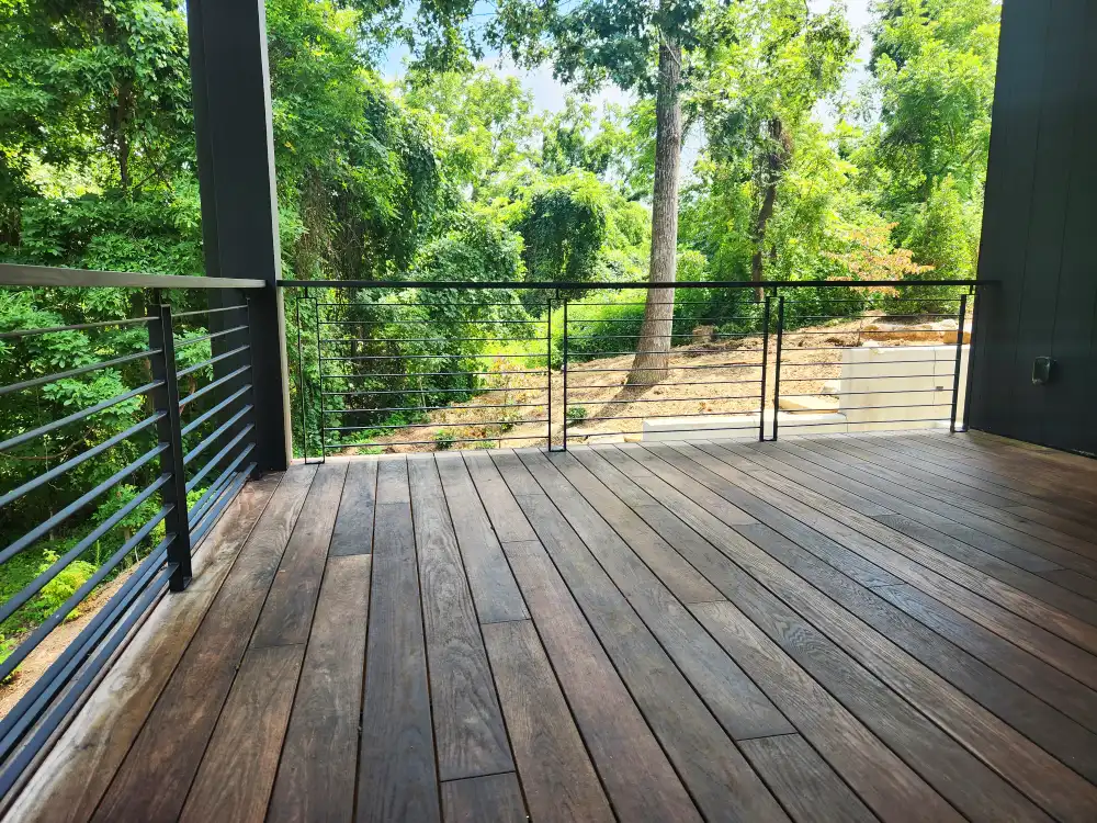 Custom powder-coated exterior deck railing with wood top rail